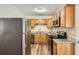 Well-equipped kitchen with stainless steel appliances and warm wood cabinets at 108 N Truett St, Leesburg, FL 34748