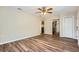 Bright living room with wood floors, a ceiling fan, and access to the kitchen at 108 N Truett St, Leesburg, FL 34748