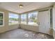 Bright screened porch offering a view of the neighborhood, freshly painted with a front door at 108 N Truett St, Leesburg, FL 34748