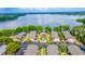 Stunning aerial view showcases the community pool, buildings, lush landscaping, and the serene lake at 1177 Paseo Del Mar # D, Casselberry, FL 32707