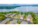 Community aerial view of lakeside apartments, pool area, parking lot, and mature trees at 1177 Paseo Del Mar # D, Casselberry, FL 32707