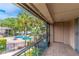 Balcony view overlooking the community pool and lush landscaping with a glimpse of the lake at 1177 Paseo Del Mar # D, Casselberry, FL 32707