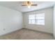 Well-lit bedroom featuring a ceiling fan and a window offering natural light at 1177 Paseo Del Mar # D, Casselberry, FL 32707