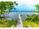 Scenic view of a private dock on a tranquil lake with lush greenery at 1177 Paseo Del Mar # D, Casselberry, FL 32707