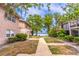 Exterior view of the property showcasing landscaped grounds, walkways, and lake views at 1177 Paseo Del Mar # D, Casselberry, FL 32707