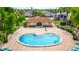 Aerial view of community pool area with relaxing lounge seating near lake at 1177 Paseo Del Mar # D, Casselberry, FL 32707