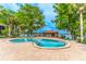 Community pool area offering ample seating and shaded lounge space with lake view at 1177 Paseo Del Mar # D, Casselberry, FL 32707