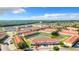 Aerial view of a community with a pond, trees, and multiple buildings with red tile roofs at 1201 S Beach Cir, Kissimmee, FL 34746