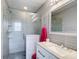 Bright bathroom with a glass shower, a white vanity with granite countertop, and modern fixtures at 1201 S Beach Cir, Kissimmee, FL 34746