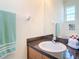 Well-lit bathroom featuring a clean vanity, large mirror, and modern fixtures at 1201 S Beach Cir, Kissimmee, FL 34746