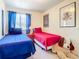 Bright bedroom with twin beds, carpeted floor, and framed art on the walls at 1201 S Beach Cir, Kissimmee, FL 34746