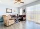 Cozy living room with comfortable seating, ceiling fan, and sliding glass doors to the outside at 1201 S Beach Cir, Kissimmee, FL 34746