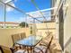 Spacious screened patio with tiled flooring, outdoor furniture, and a view of the surrounding neighborhood at 1201 S Beach Cir, Kissimmee, FL 34746