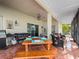 Covered patio with outdoor dining table, grill, and comfortable seating at 1319 Castleport Rd, Winter Garden, FL 34787