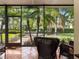 Enclosed lanai with tile floor overlooking landscaped backyard and a tranquil water feature at 1319 Castleport Rd, Winter Garden, FL 34787