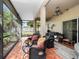 A screened in patio with stylish furniture and an outdoor grill at 1319 Castleport Rd, Winter Garden, FL 34787