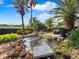 Backyard rock water feature with lush tropical landscaping at 1319 Castleport Rd, Winter Garden, FL 34787