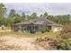 The backyard features a lovely screened-in pool and is surrounded by green grass at 13780 Sw 78Th Pl, Dunnellon, FL 34432