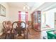 Dining area featuring hardwood floors, a charming china cabinet, and ample natural light at 13780 Sw 78Th Pl, Dunnellon, FL 34432