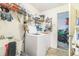 Laundry room with sink, washer, shelving, and clutter at 13780 Sw 78Th Pl, Dunnellon, FL 34432