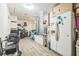 Cluttered room with a freezer, chair, and wood laminate flooring at 13780 Sw 78Th Pl, Dunnellon, FL 34432
