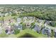 Wide aerial shot featuring the pool, backyard, and surrounding neighborhood with wooded backdrop at 14545 Braddock Oak Dr, Orlando, FL 32837