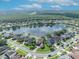 Wide aerial of lakeside neighborhood with a view of the surrounding community and wooded areas at 14545 Braddock Oak Dr, Orlando, FL 32837