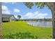 Expansive backyard view featuring lush green grass and serene lake views, perfect for relaxation and outdoor enjoyment at 14545 Braddock Oak Dr, Orlando, FL 32837