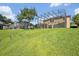 Backyard view highlighting the screened enclosure and meticulously maintained lawn at 14545 Braddock Oak Dr, Orlando, FL 32837