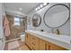 This bathroom features a double vanity, glass shower, and stylish mirrors at 14545 Braddock Oak Dr, Orlando, FL 32837