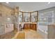 Elegant bathroom features a glass shower, soaking tub, and vanity with ample counter space at 14545 Braddock Oak Dr, Orlando, FL 32837