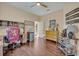 Bedroom featuring dark wood flooring, a ceiling fan, and access to the exterior at 14545 Braddock Oak Dr, Orlando, FL 32837