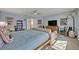 This is a spacious primary bedroom featuring a seating area, TV, and lots of natural light at 14545 Braddock Oak Dr, Orlando, FL 32837