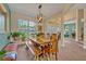 Bright and spacious dining area featuring a long wooden table, bench seating, and ample natural light at 14545 Braddock Oak Dr, Orlando, FL 32837