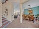 Open-concept entryway with decorative stairs leading to a dining area and a living room with ample natural light at 14545 Braddock Oak Dr, Orlando, FL 32837