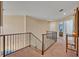 Upstairs hallway with iron railing and access to bedrooms at 14545 Braddock Oak Dr, Orlando, FL 32837
