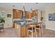 Modern kitchen boasts wooden cabinetry, stainless steel appliances, a kitchen island, and stylish pendant lighting fixtures at 14545 Braddock Oak Dr, Orlando, FL 32837
