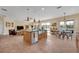 Open kitchen with large island, stainless steel appliances, and adjacent dining area overlooking the lake at 14545 Braddock Oak Dr, Orlando, FL 32837