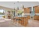 Well-equipped kitchen with island, stainless appliances, custom cabinetry, and easy access to outdoor living space at 14545 Braddock Oak Dr, Orlando, FL 32837