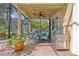 Covered patio with outdoor seating, a grill, and views of the pool and lush greenery at 14545 Braddock Oak Dr, Orlando, FL 32837