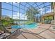 Enclosed pool area offering scenic lake views and a relaxing outdoor space with ample seating at 14545 Braddock Oak Dr, Orlando, FL 32837