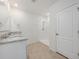 Bright bathroom featuring dual sinks, granite countertops, and a glass-enclosed shower at 1511 Barberry Dr, Kissimmee, FL 34744