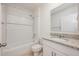 Well-lit bathroom with a single sink vanity, granite countertop, and a shower-tub combination at 1511 Barberry Dr, Kissimmee, FL 34744
