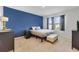 Comfortable bedroom with a calming blue accent wall, ample natural light, and stylish furniture at 1511 Barberry Dr, Kissimmee, FL 34744