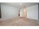 A carpeted room leads to another room, with neutral walls and carpet, awaiting your personal touch at 1511 Barberry Dr, Kissimmee, FL 34744