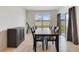 Dining room with a modern table setting and natural light from the sliding glass door at 1511 Barberry Dr, Kissimmee, FL 34744