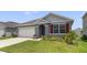 Charming one-story home featuring a well-manicured lawn and a two-car garage at 1511 Barberry Dr, Kissimmee, FL 34744