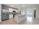 Bright, open kitchen with stainless steel appliances and granite countertops, seamlessly connected to the living area at 1511 Barberry Dr, Kissimmee, FL 34744
