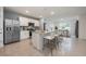 Open kitchen with stainless steel appliances, granite countertops, and a breakfast bar island at 1511 Barberry Dr, Kissimmee, FL 34744