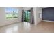 A living area with large windows and tile flooring, offering abundant natural light and a view of the backyard at 1511 Barberry Dr, Kissimmee, FL 34744